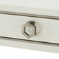 Close-up of a metallic handle on a white textured surface