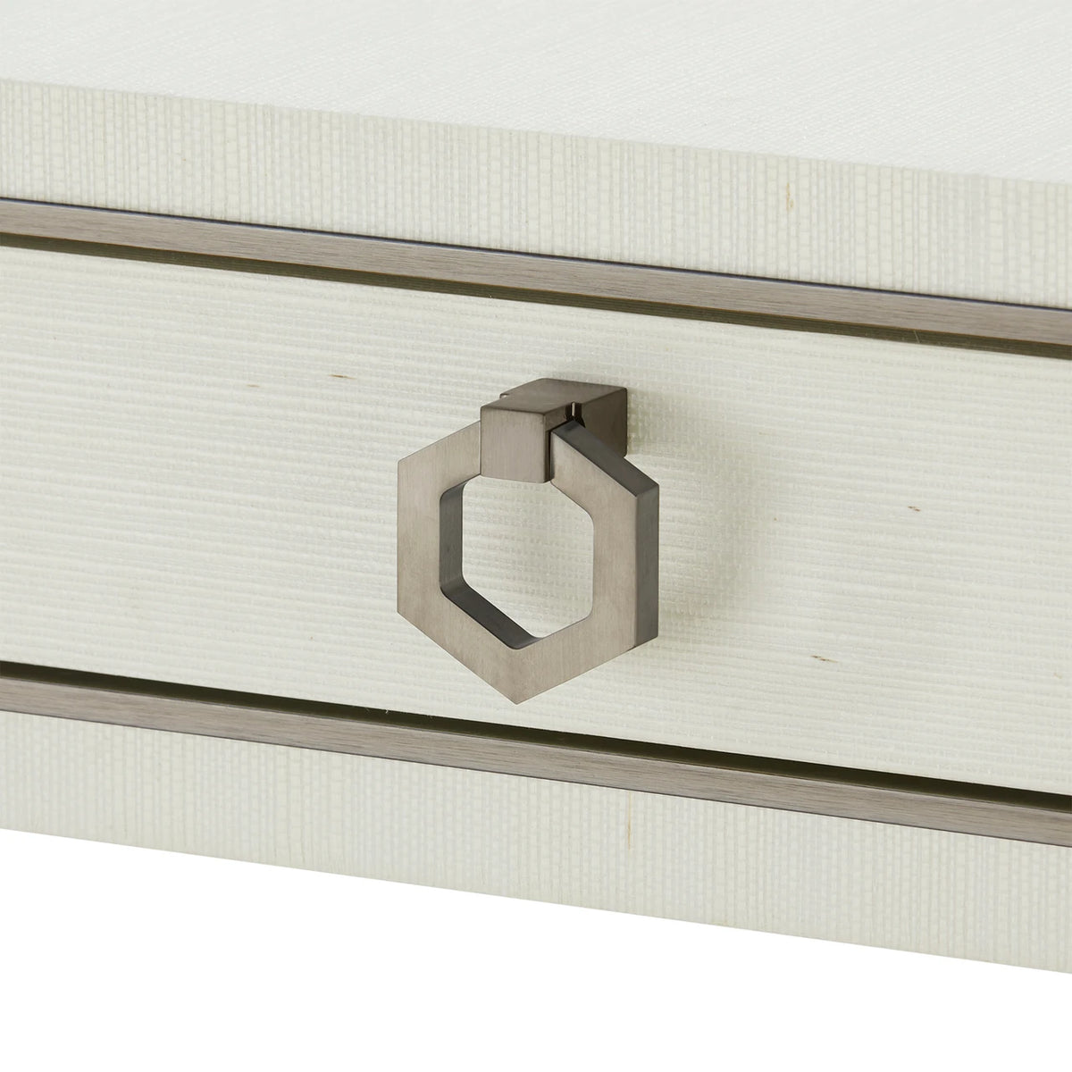 Close-up of a metallic handle on a white textured surface