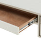 Wooden drawer being pulled out from a white cabinet.