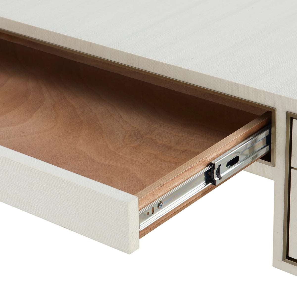Wooden drawer being pulled out from a white cabinet.