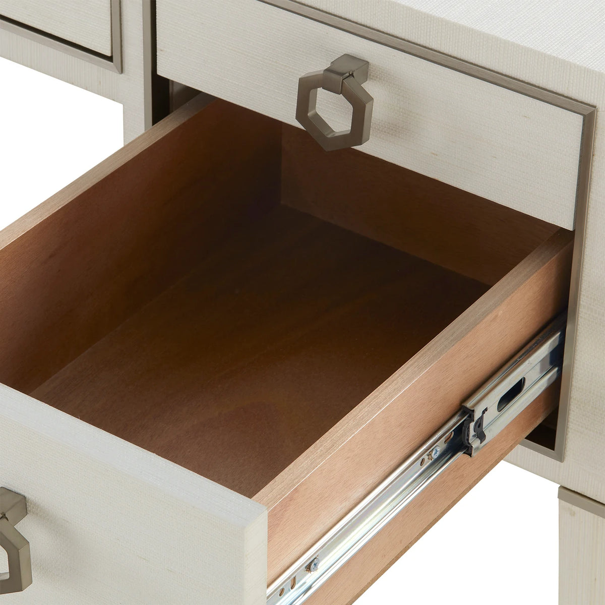 Open drawer of a piece of furniture with a metallic handle.