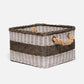 Wicker storage basket with two handles on a white background