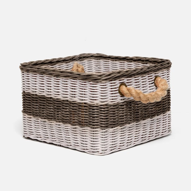 Wicker storage basket with two handles on a white background