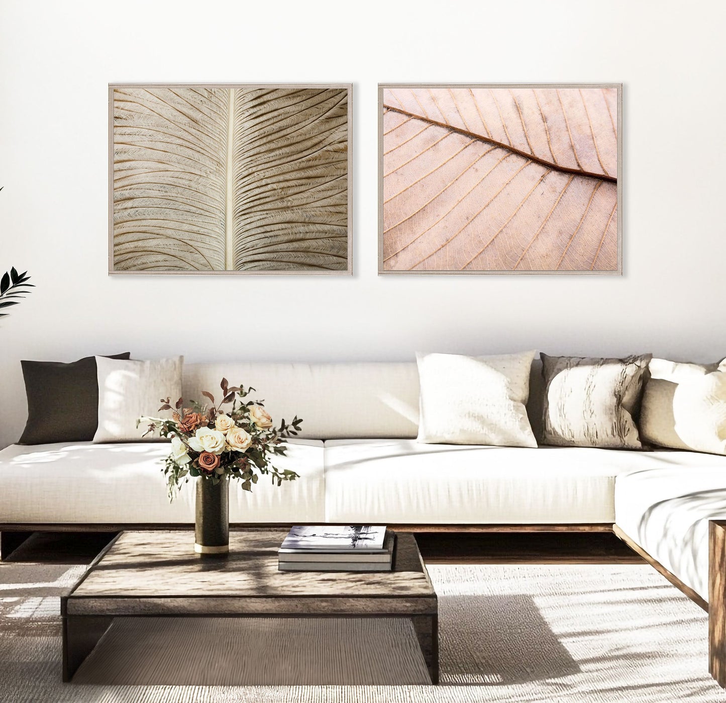 Living room with a white sofa, wooden coffee table, and wall art of leaf designs.