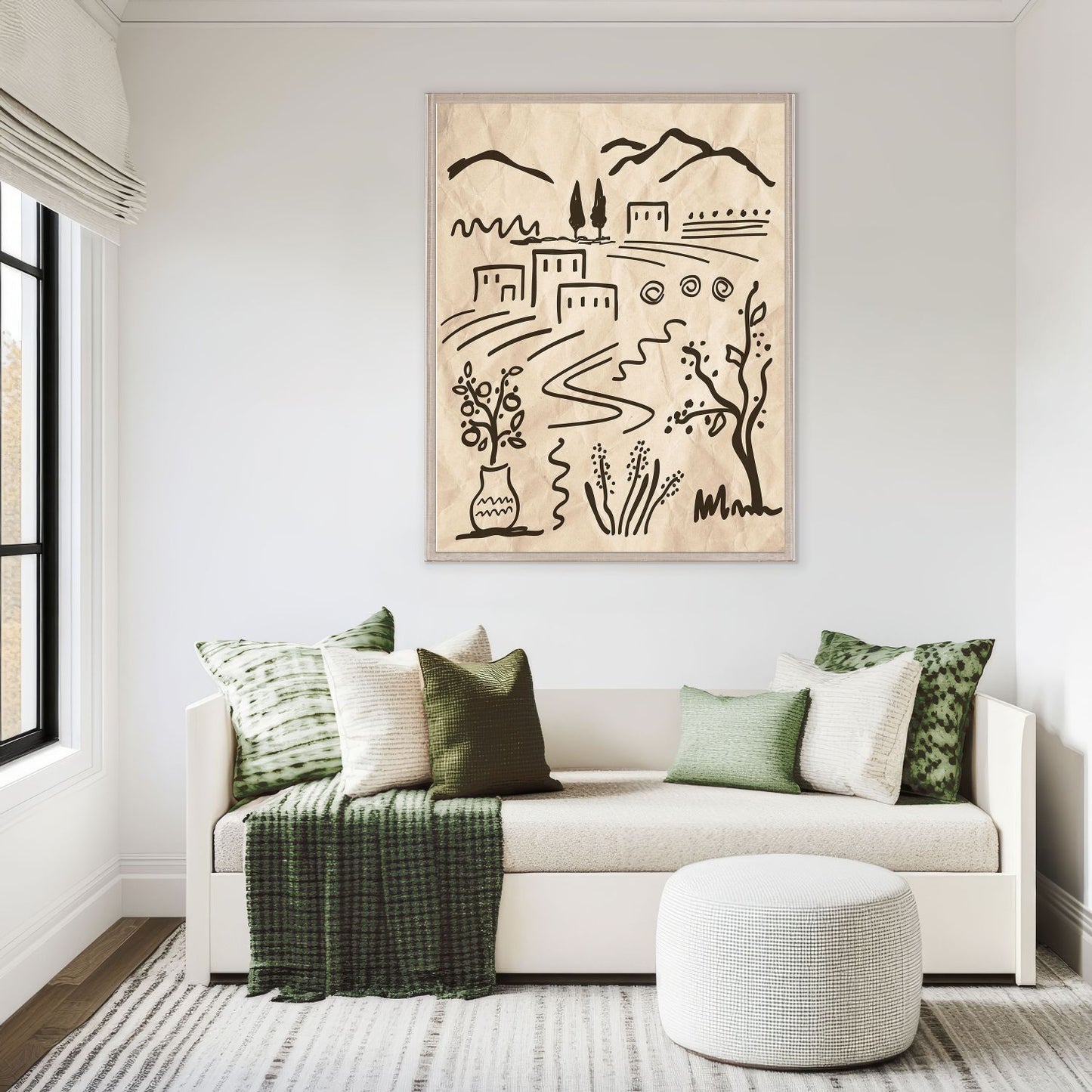 Living room with a white sofa, green pillows, and a framed artwork on the wall.