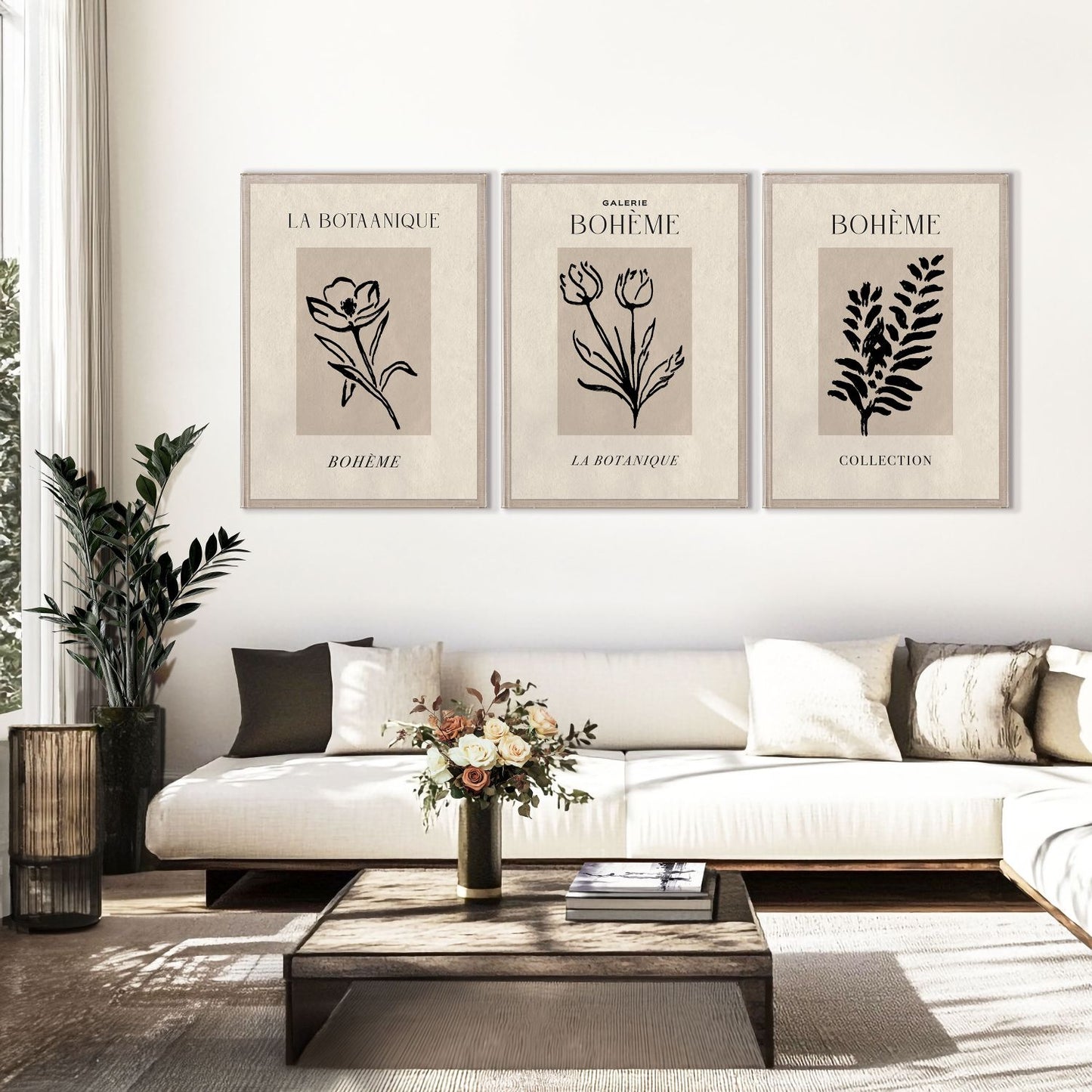 Living room with a white sofa, wooden coffee table, and framed botanical prints on the wall.