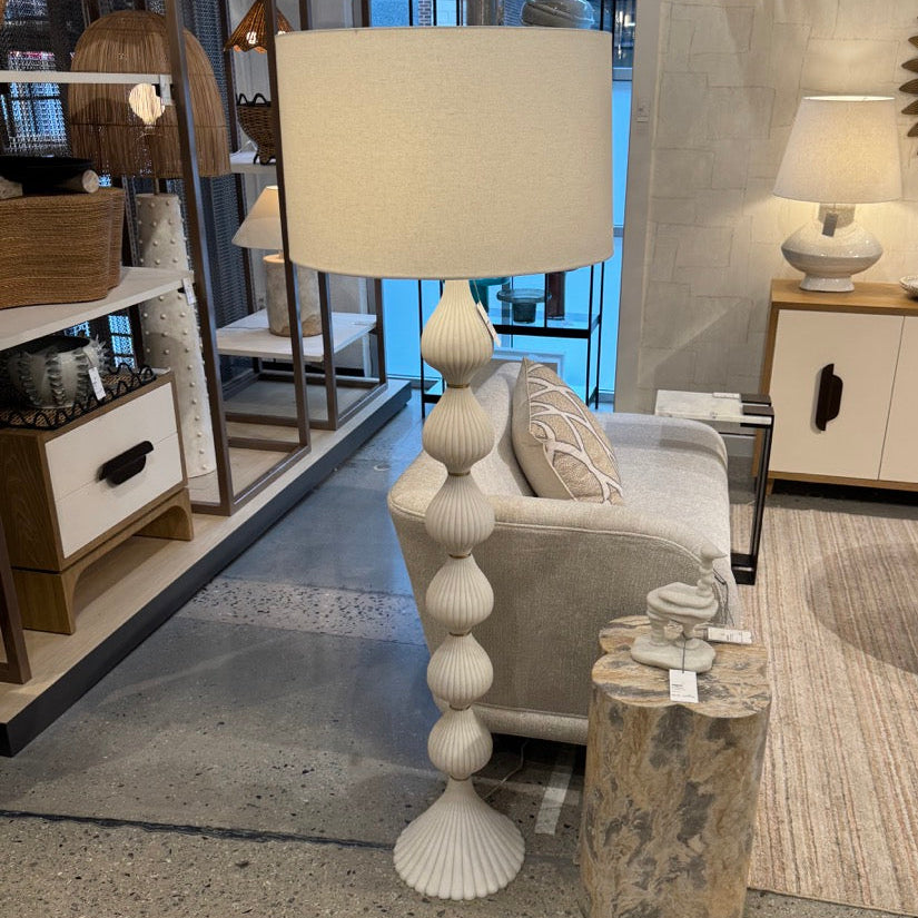 Living room with a white lamp, gray sofa, and decorative items.