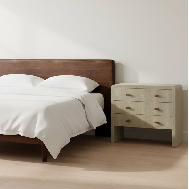 Bedroom with wooden bed and nightstand against a white wall