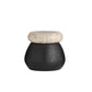 Small black vase with a beige marble cap on a white background