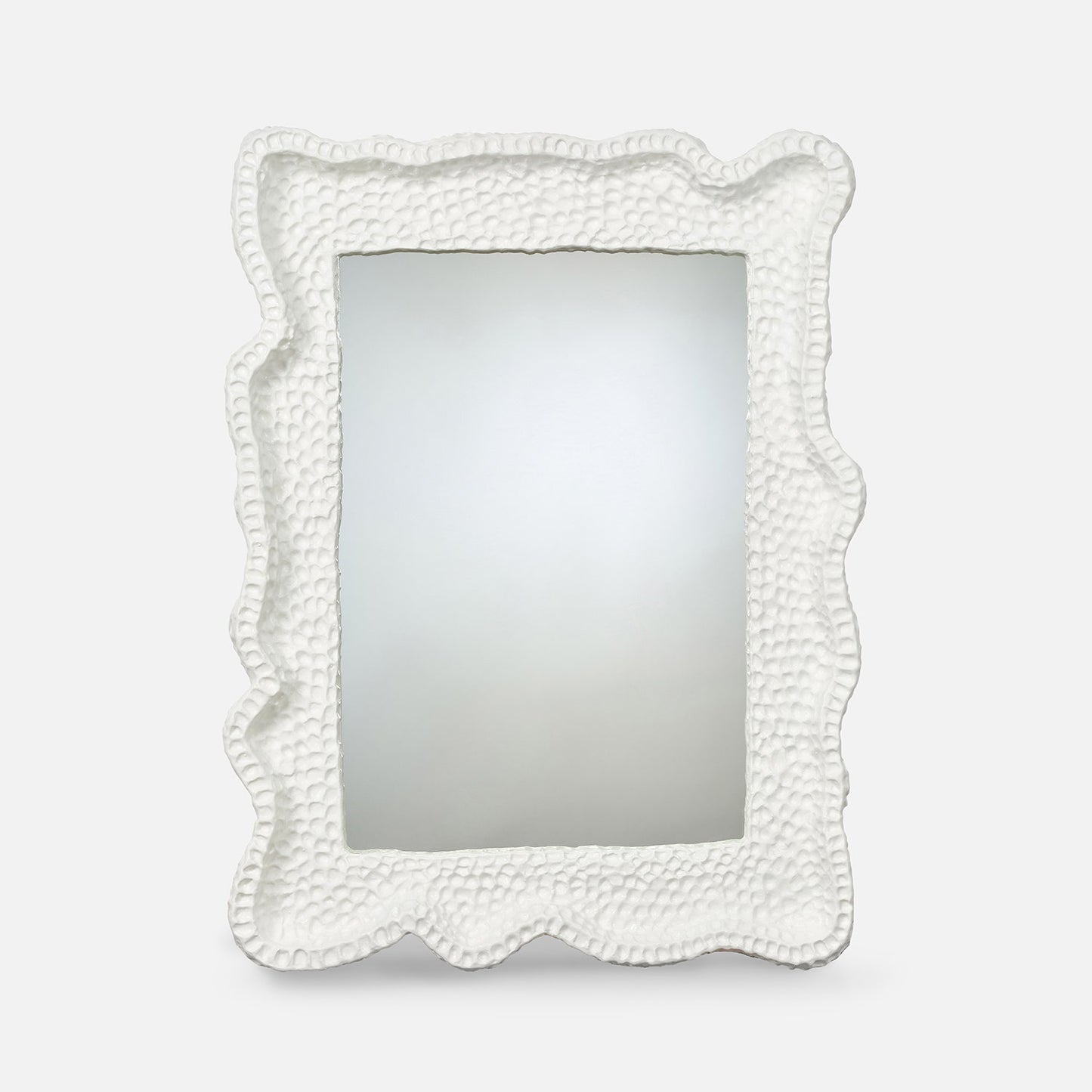 White decorative mirror with textured border on a white background