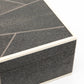 Close-up of a textured black box with a white interior