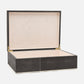 Decorative box with a black textured exterior and beige interior on a white background
