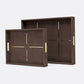 Two dark brown textured serving trays with gold metal handles and cross-shaped gold accents on the inside, shown on a light gray background.