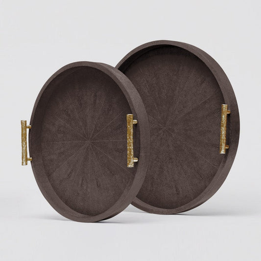 Two round wooden trays with gold handles on a light gray background