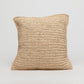 Beige woven pillow on a light gray background
