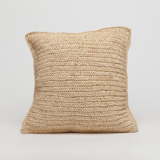 Beige woven pillow on a light gray background