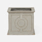 A square concrete planter with a textured light gray finish and a raised circular geometric design on the front, set against a plain white background.