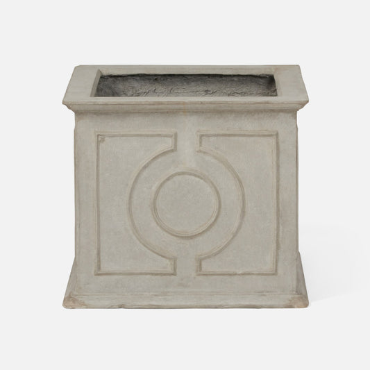 A square concrete planter with a textured light gray finish and a raised circular geometric design on the front, set against a plain white background.