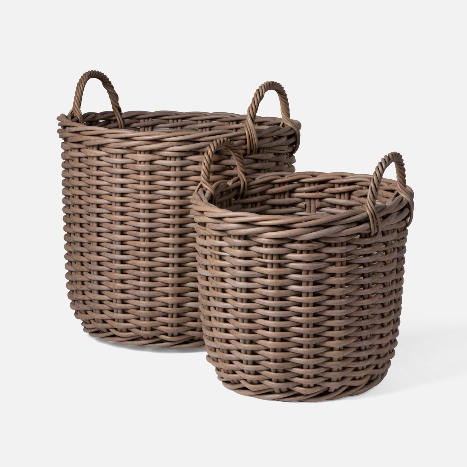 Two wicker baskets with handles on a white background