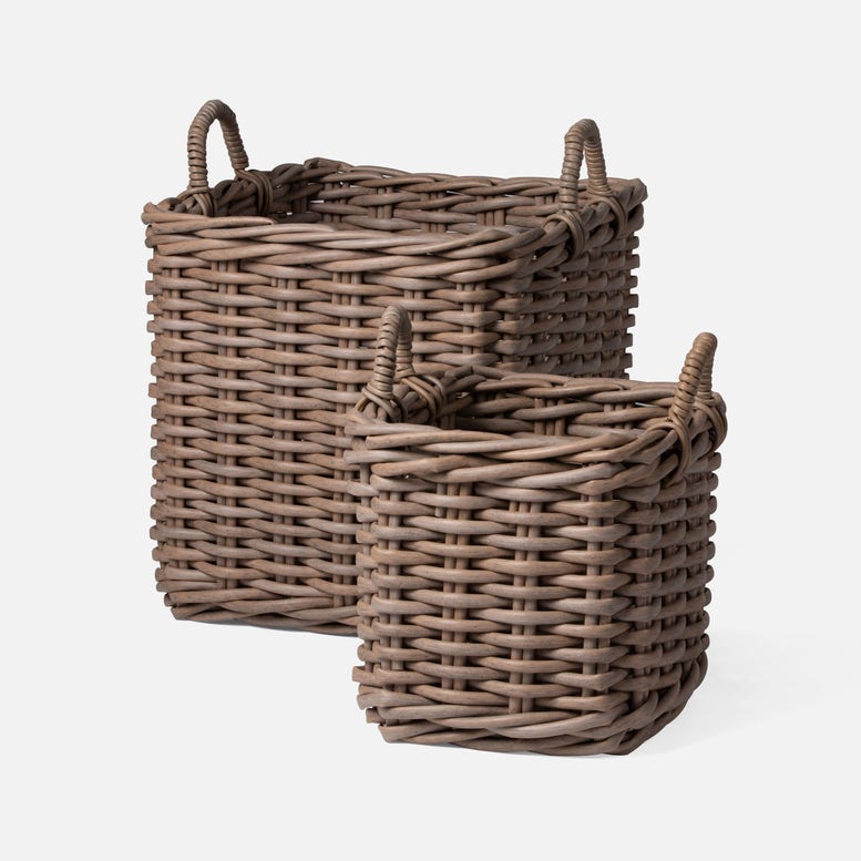 Two wicker baskets with handles on a white background