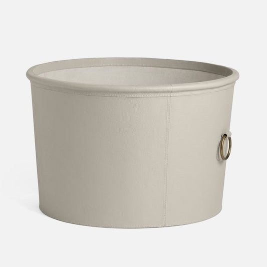 light gray round storage basket with a handle on a white background