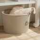 light gray laundry basket with a woven lid on a wooden floor