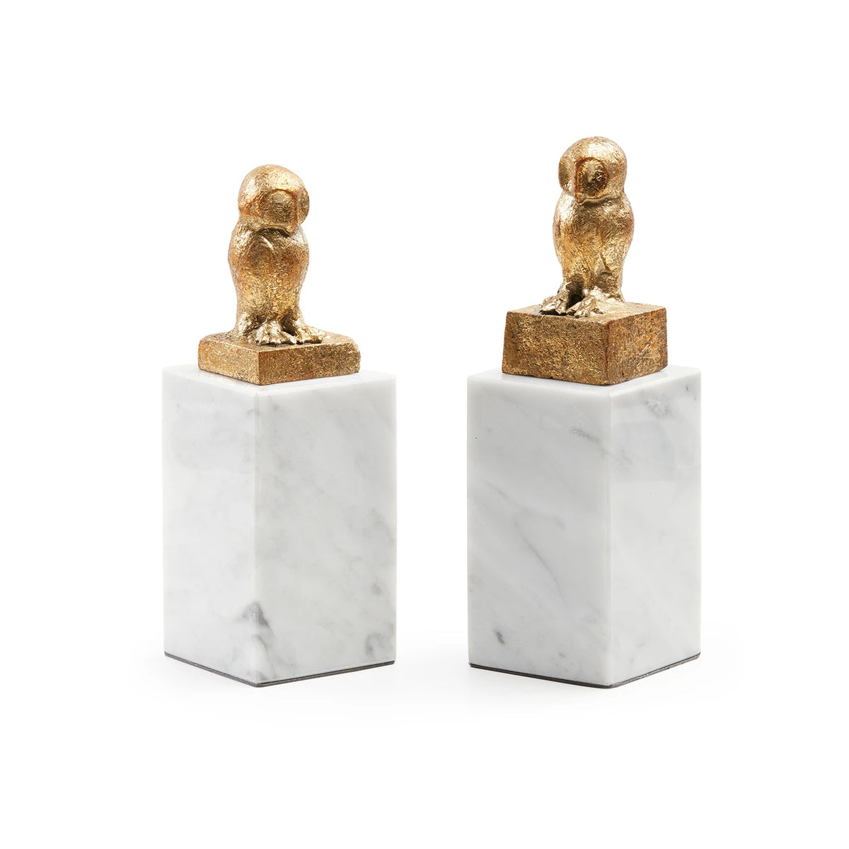 A pair of decorative bookends featuring gold owl figurines on a textured gold block, mounted on white marble bases, set against a plain white background.
