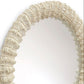 Round mirror with a decorative beige frame on a white background
