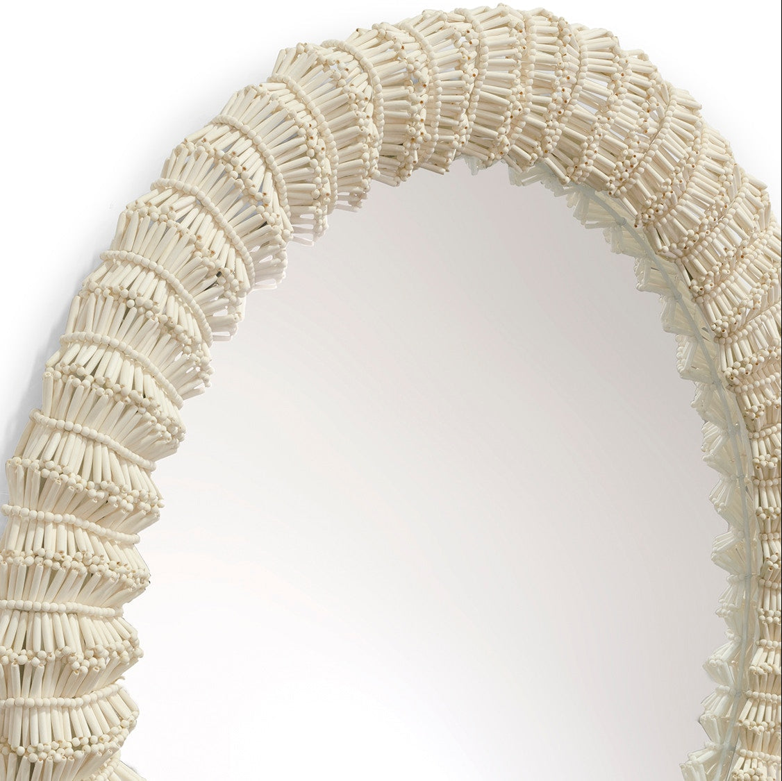 Round mirror with a decorative beige frame on a white background