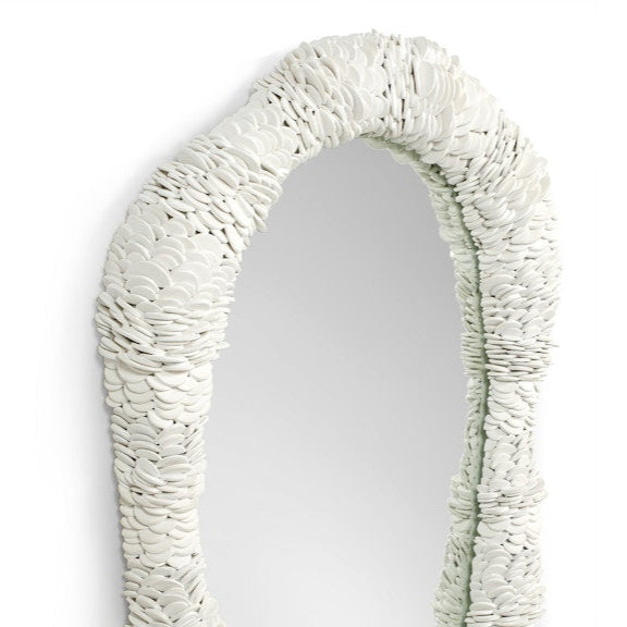 Oval mirror with a textured white frame on a white background