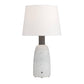 Table lamp with a textured white base and white shade on a white background
