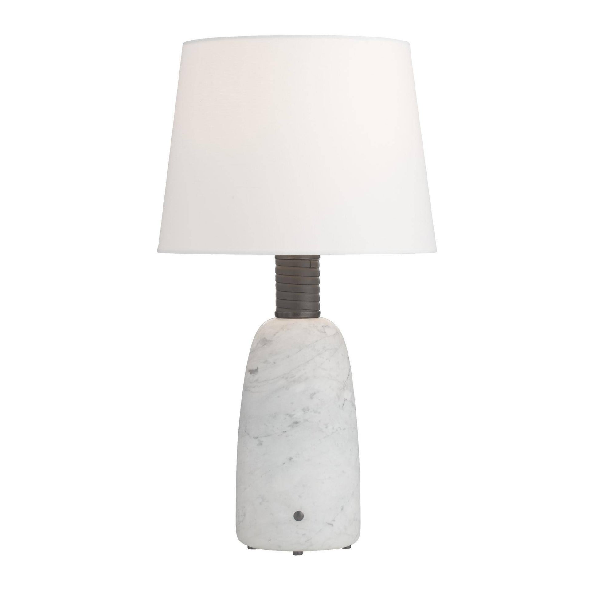Table lamp with a textured white base and white shade on a white background
