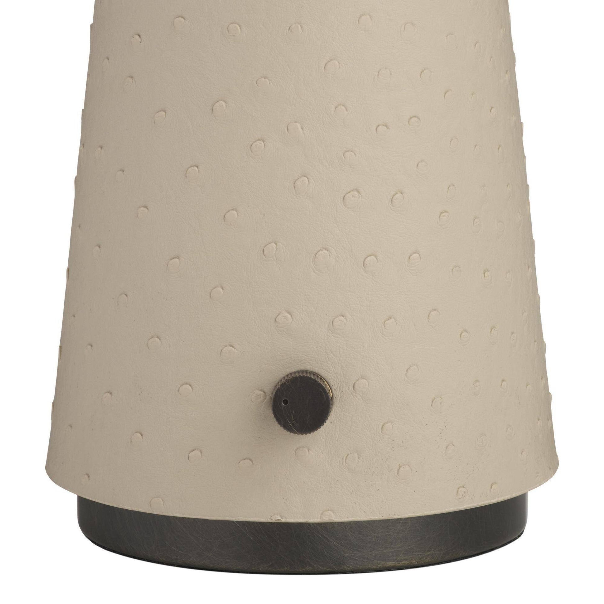 Textured beige lampshade with a black base on a white background