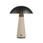 Table lamp with black dome shade and beige cylindrical base on a white background