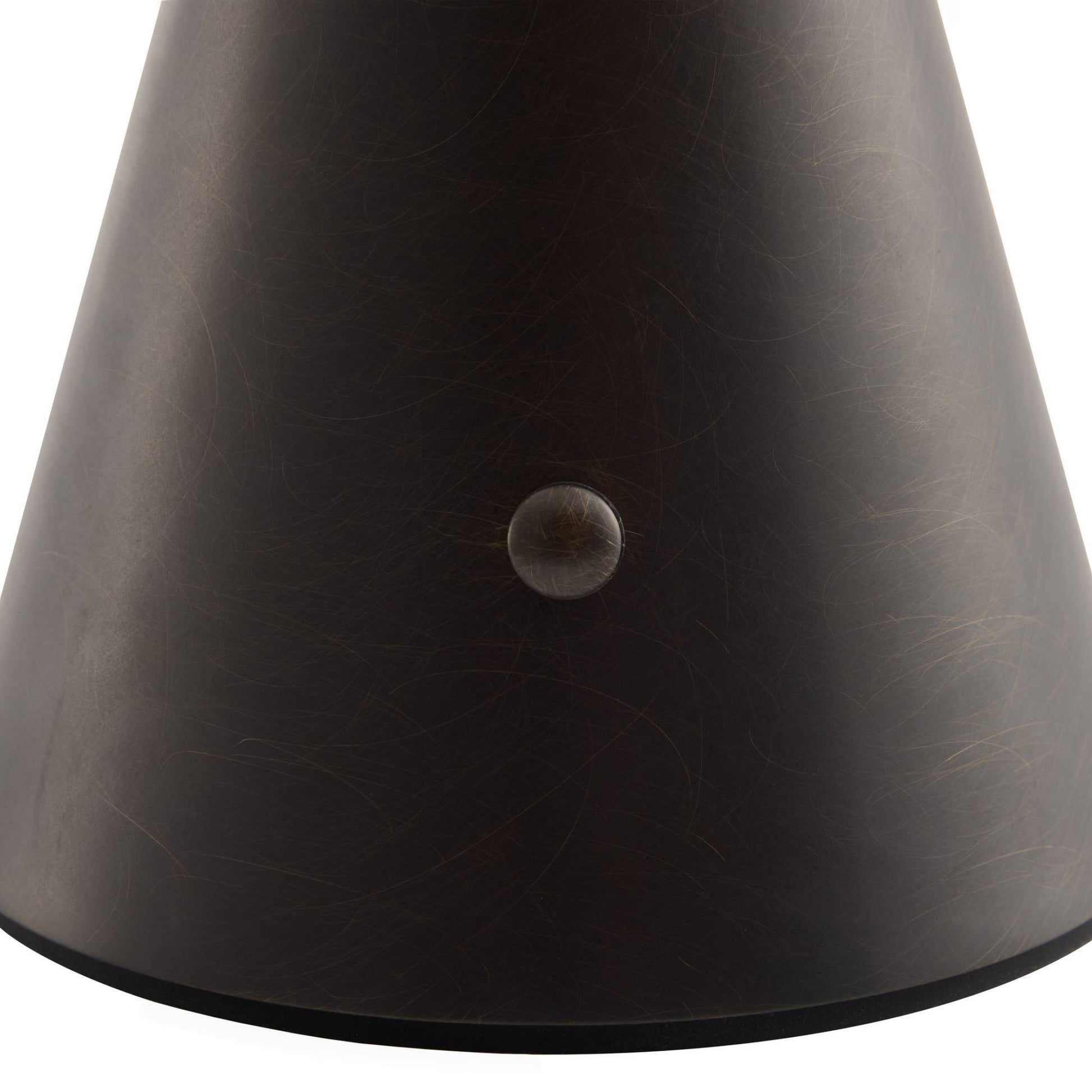 Close-up of a dark brown leather product with a button on a white background