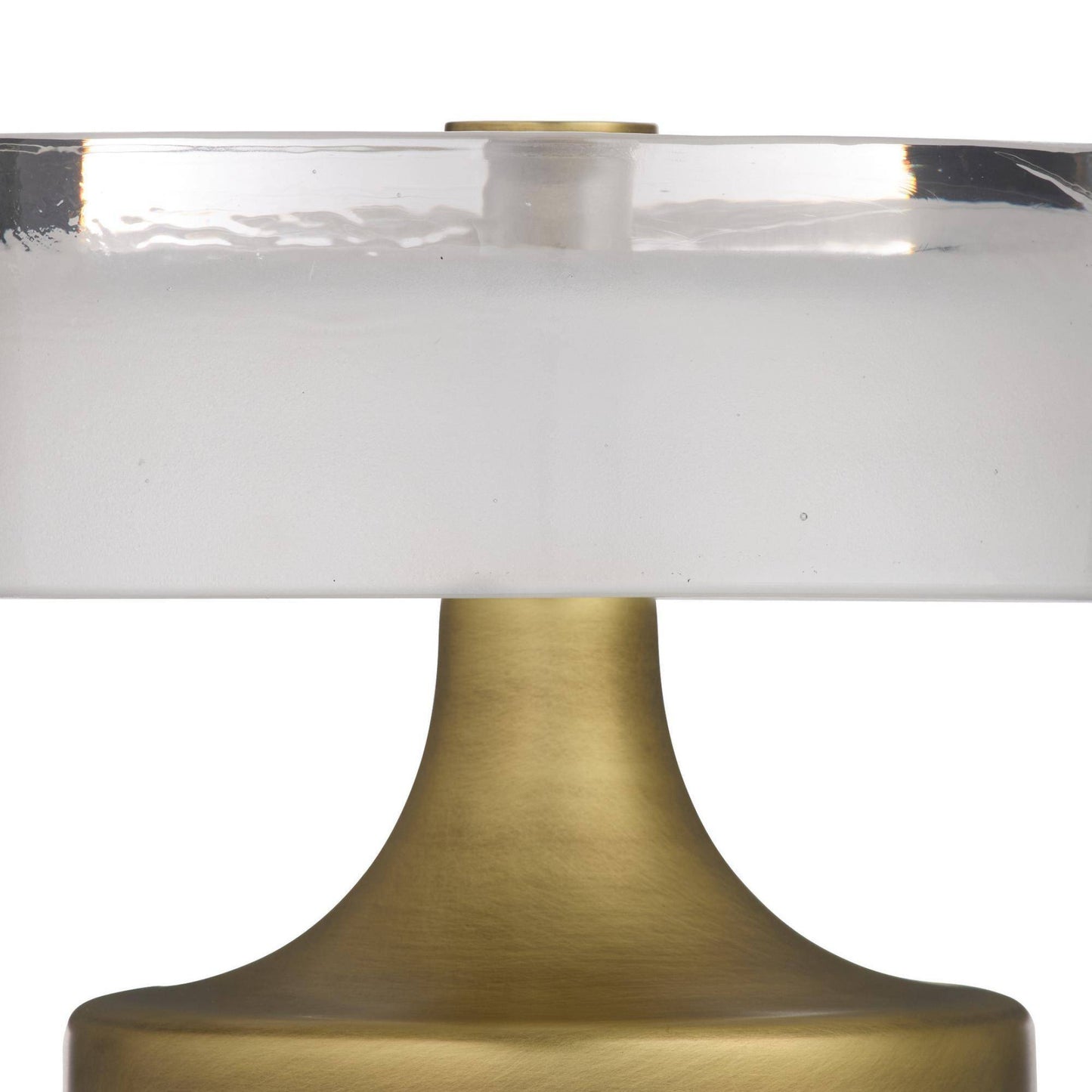 Close-up of a table lamp with a gold base and clear glass shade on a white background