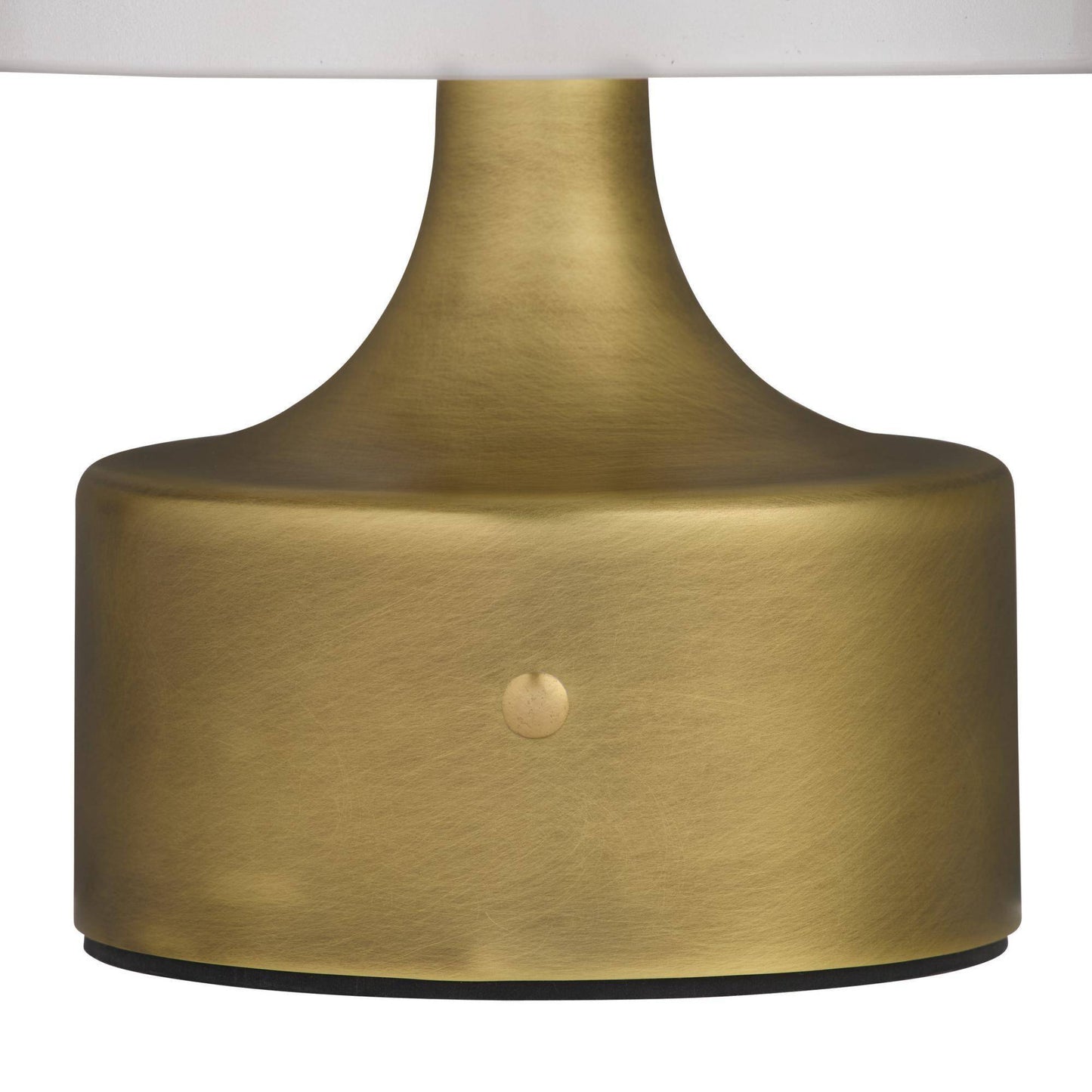 Close-up of a gold lamp base with a white shade on a white background