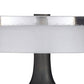 Close-up of a round glass table with a black base on a white background