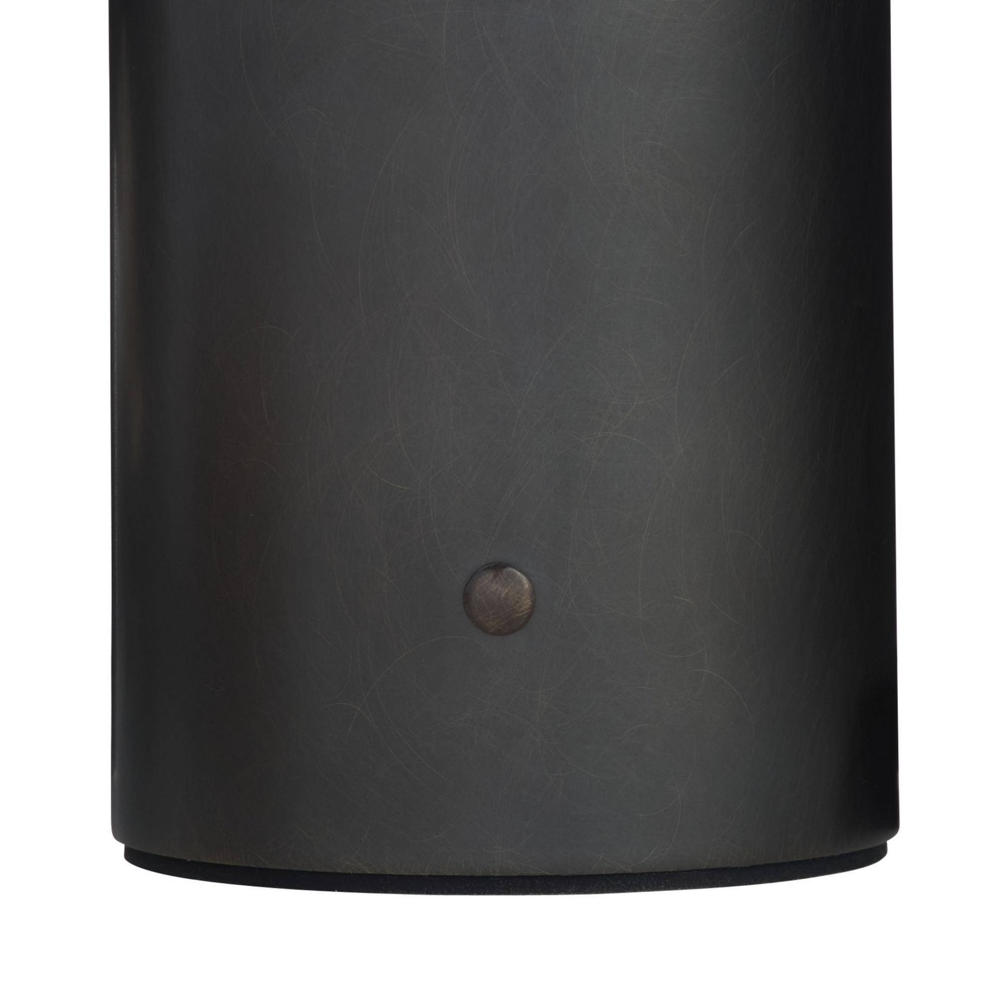 Black cylindrical object with a button on a white background