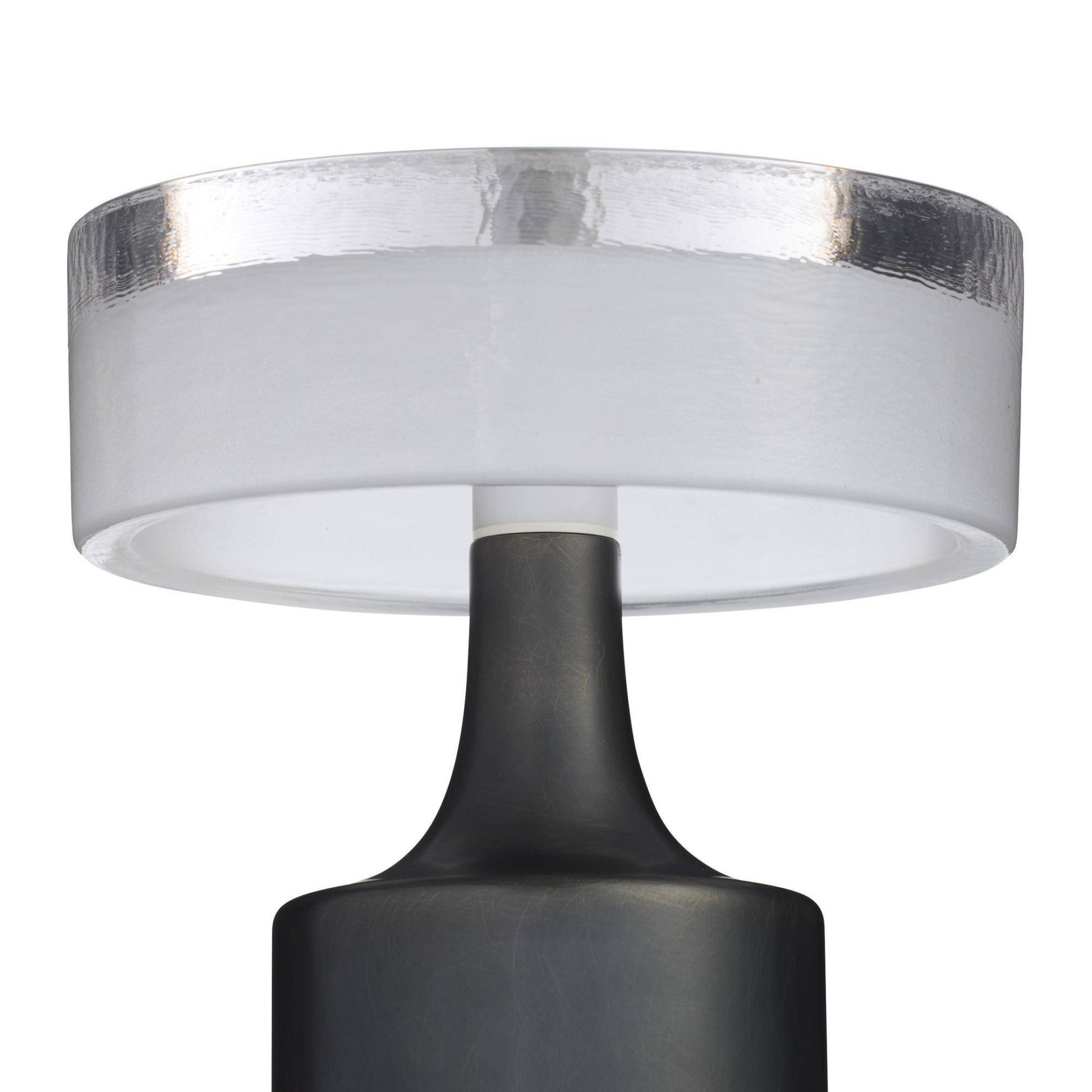 Close-up of a lamp with a white shade and black base on a white background