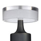 Close-up of a lamp with a white shade and black base on a white background