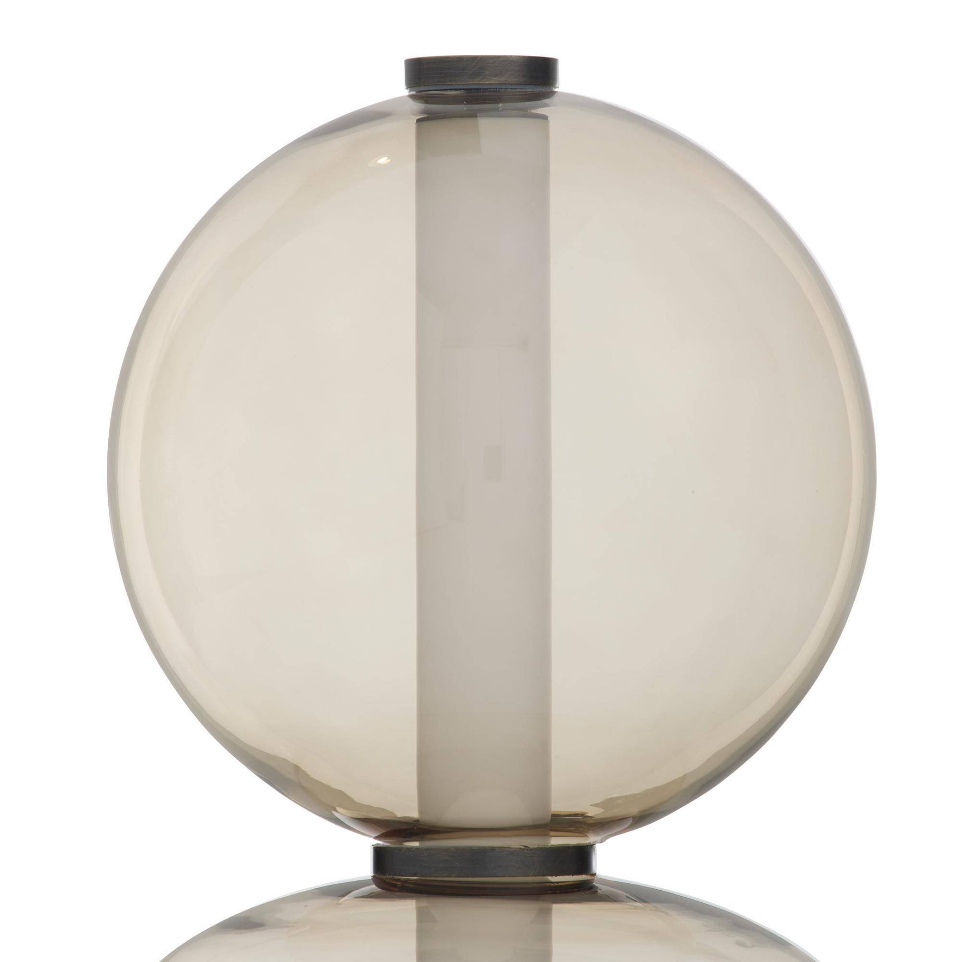 A spherical glass shade or lamp body in smoky translucent amber-tinted glass, shown against a plain white background with a soft reflection below.