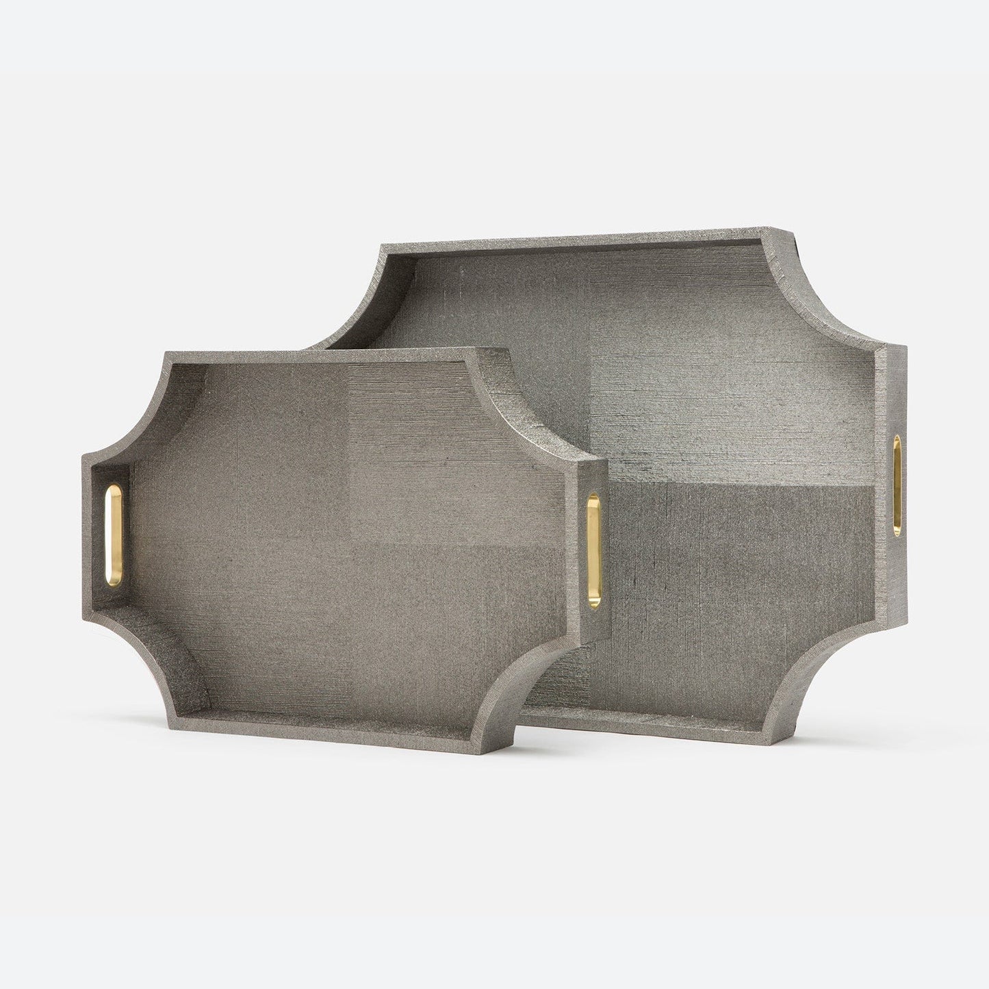 Two gray textured trays with gold handles on a white background