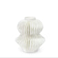 A white ceramic vase with a sculptural, pleated, accordion-like textured design, shown against a seamless white background.