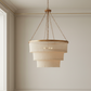 Chandelier hanging from the ceiling in a room with neutral walls.
