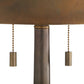 Close-up of a lamp with a brown shade and metallic pull chains on a white background