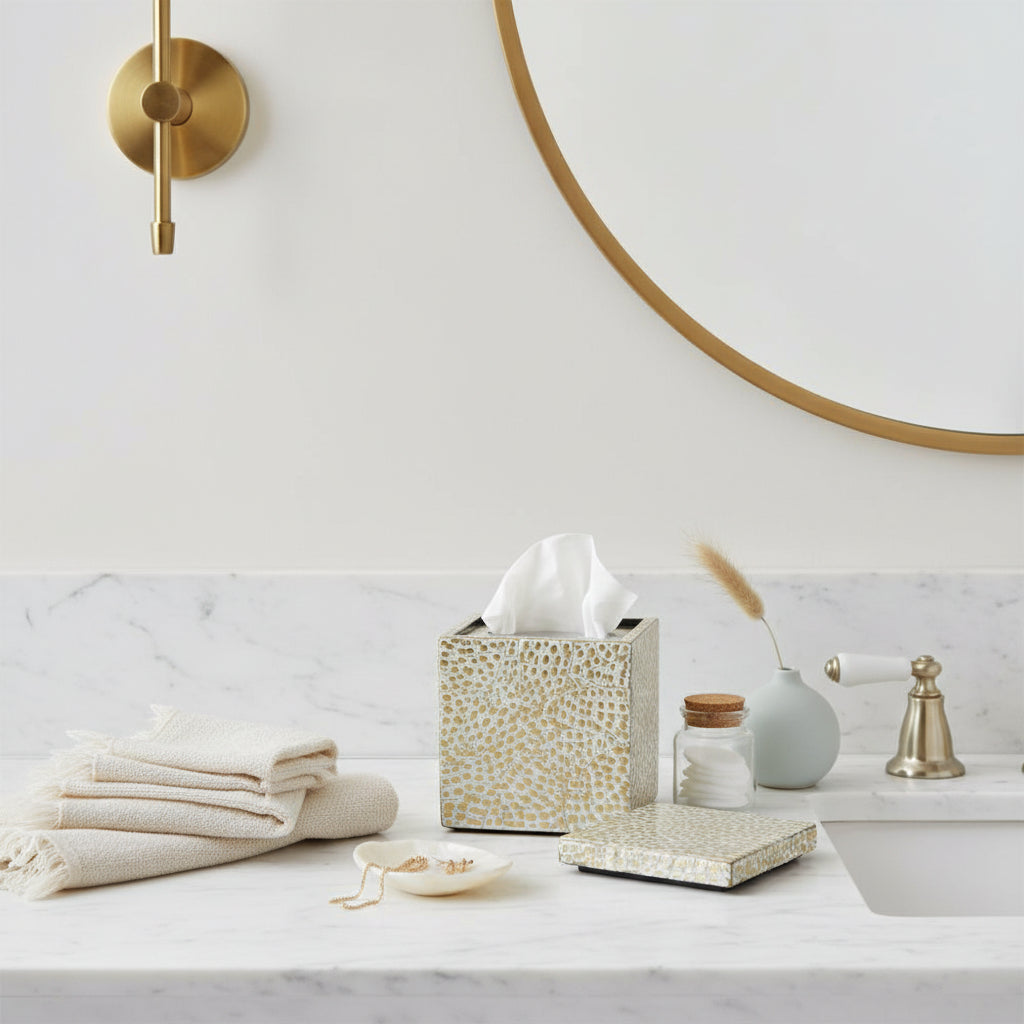 A square decorative container with a textured, pebbled surface in beige and white, shown with its lid propped open and white fluffy cotton balls inside.