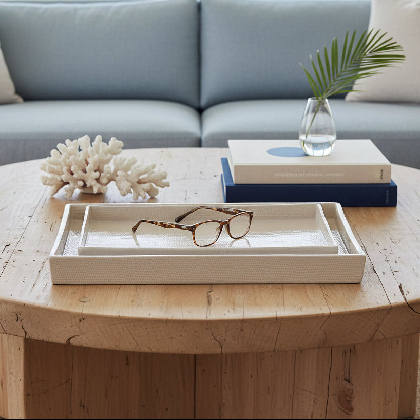 A set of two nested rectangular trays in a light beige or cream color, photographed against a clean, light gray studio background.