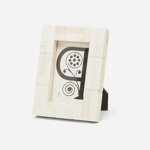 Beige picture frame with a decorative letter 'P' on a white background