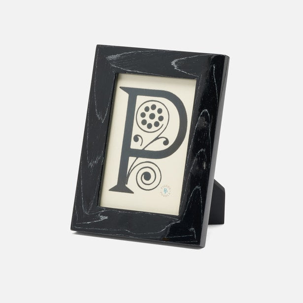 Black decorative frame with a letter 'P' design on a white background